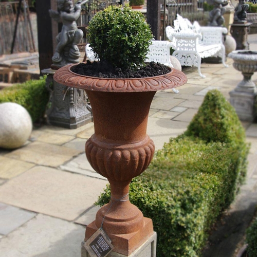 46 - Pair of period style cast iron urns sitting on a small square stone plinth. (Plants not included). {... 