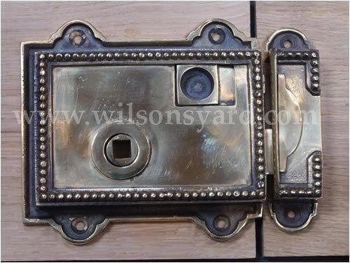Cast brass Rim Latch {10.8 cm H x 11.4 cm W x 2.5 cm D}.
