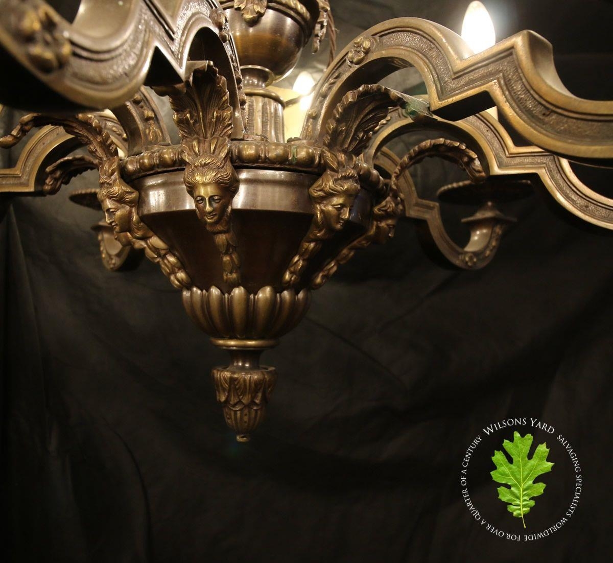 Bronzed metal eight branch chandelier with stem surmounted by cherubs ...