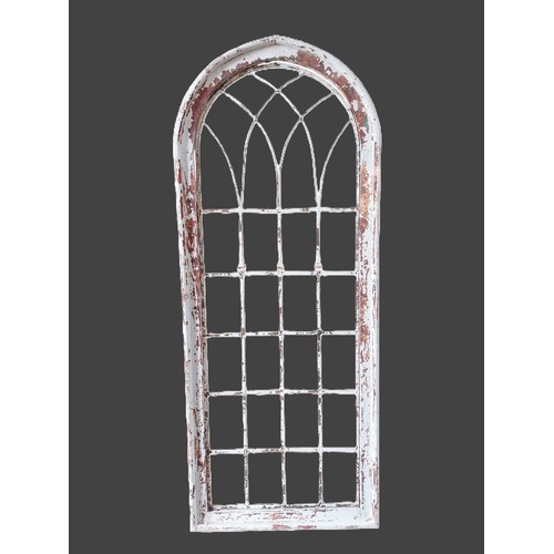 Painted hardwood arched window surround with decorative metal inserts ...