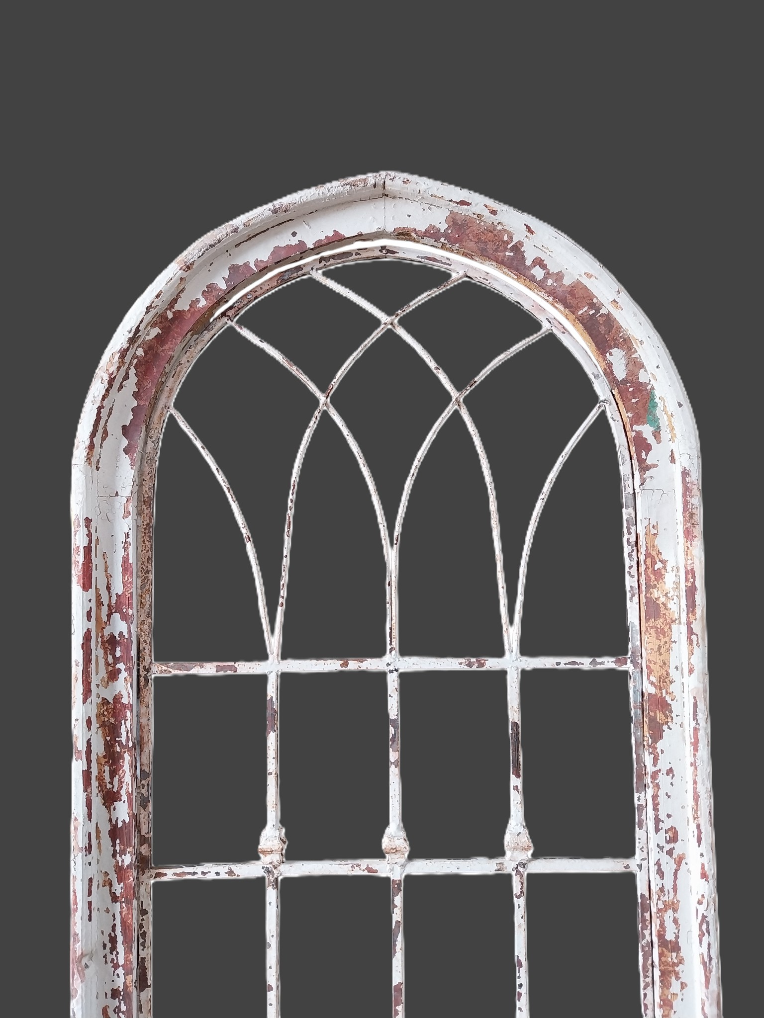 Painted hardwood arched window surround with decorative metal inserts ...