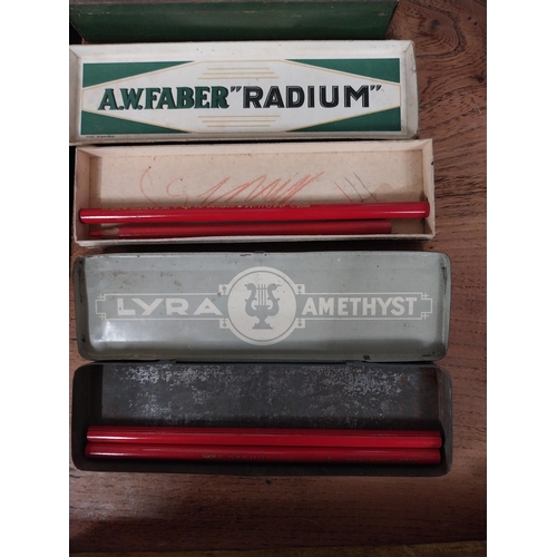 13 - Two 20th C. pencil tins - Lyra and A W Faber. {2 cm H x 28 cm W x 5 cm D}.