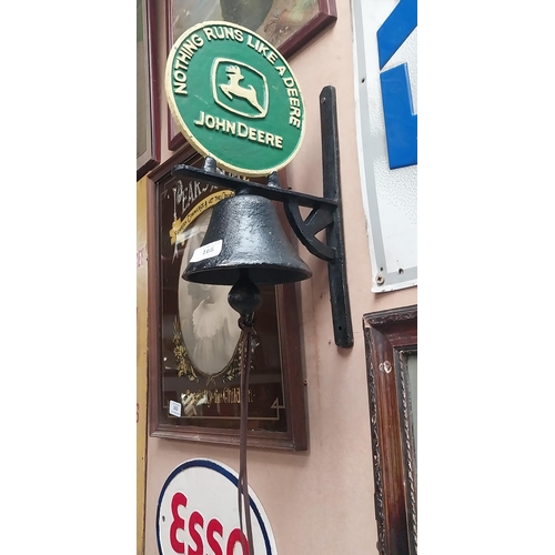 165 - John Deere Nothing Runs Like A Deere cast iron wall bell on bracket. {40 cm H x 23 cm Dia.}.