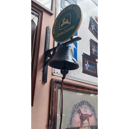 165 - John Deere Nothing Runs Like A Deere cast iron wall bell on bracket. {40 cm H x 23 cm Dia.}.