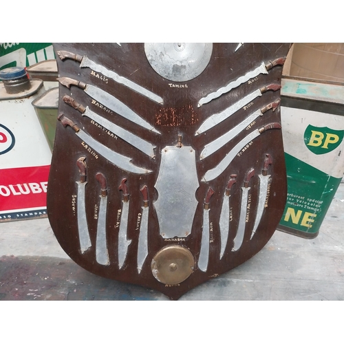 181 - Weapons of Moroland Samboanga City Philippines advertising shield. {37 cm H x 30 cm W}.