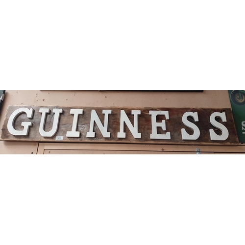 215 - Guinness wooden advertising board. {20 cm H x 122 cm W}