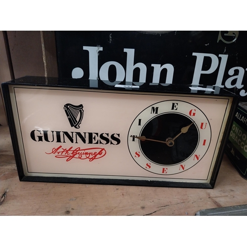 Guinness perspex battery operated clock. {18 cm H x 35 cm W x 7 cm D}.