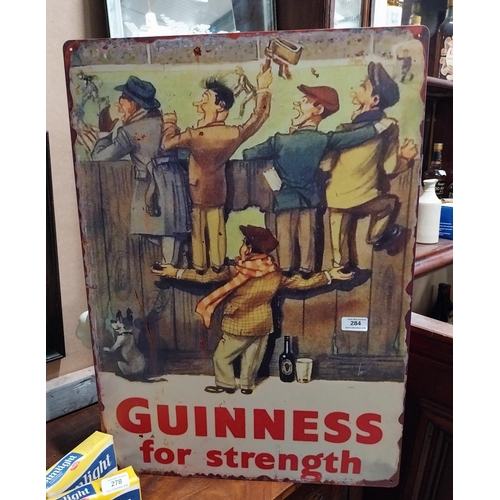284 - Guinness for Strength tin plate advertising sign. {70 cm H x 50 cm W}.