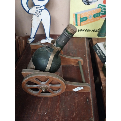 5 - Napoleon Brandy advertising model of bottle in Cannon. {27 cm H x 18 cm W x 24 cm D}.