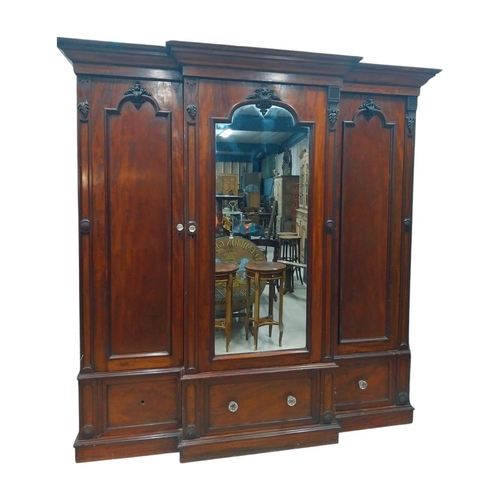 46 - 19th C. mahogany breakfront three door wardrobe with central mirrored panel above three drawers. {23... 
