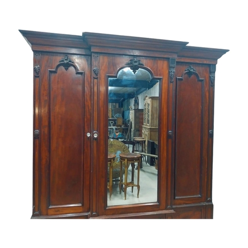 46 - 19th C. mahogany breakfront three door wardrobe with central mirrored panel above three drawers. {23... 