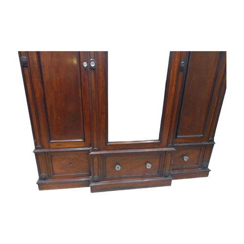 46 - 19th C. mahogany breakfront three door wardrobe with central mirrored panel above three drawers. {23... 