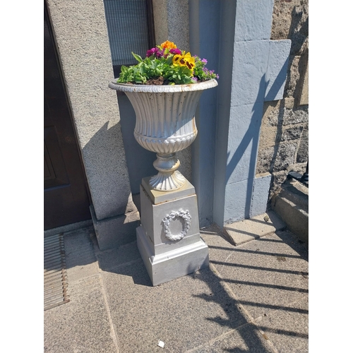 3 - Pair of 19th. C. cast iron urns, decorated with wreaths,  raised on pedestals. { 104cm H X 34cm Sq. ... 