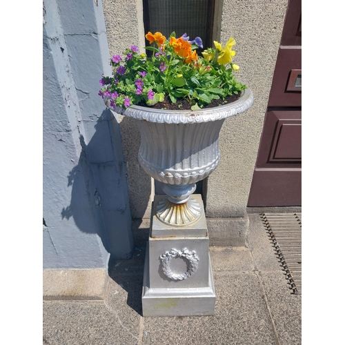 3 - Pair of 19th. C. cast iron urns, decorated with wreaths,  raised on pedestals. { 104cm H X 34cm Sq. ... 