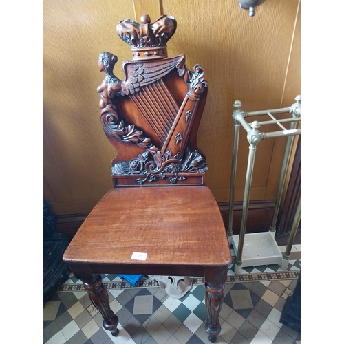 20 - Good quality 19th. C. carved mahogany hall chair with back decorated with The Hibernian Harp & Crown... 