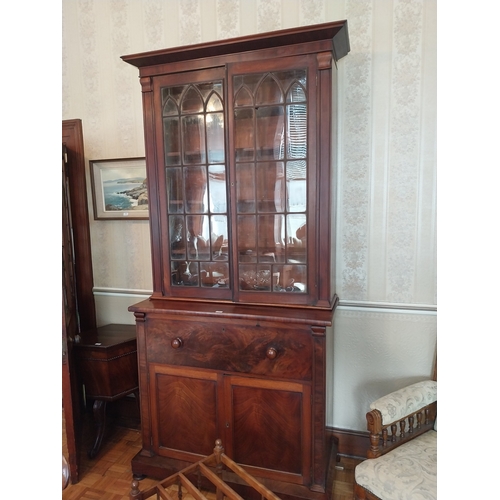 56 - Early 19th. C. mahogany bureau bookcase, the Gothic style glazed doors above a fall front and two bl... 