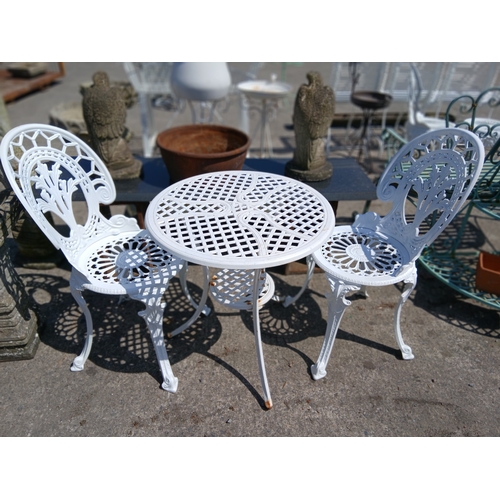 51 - Cast aluminium table and two chairs.  Table {H 65cm x Dia 68cm}. Chairs {H 88cm x W 40cm x D 40cm}. ... 