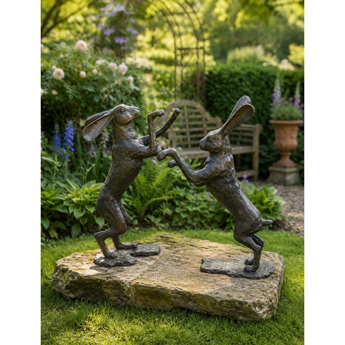 13 - Pair of bronze fighting hares on sandstone base.   Hares {H 80cm x W 30cm x D 80cm}  Base {W 126cm x... 