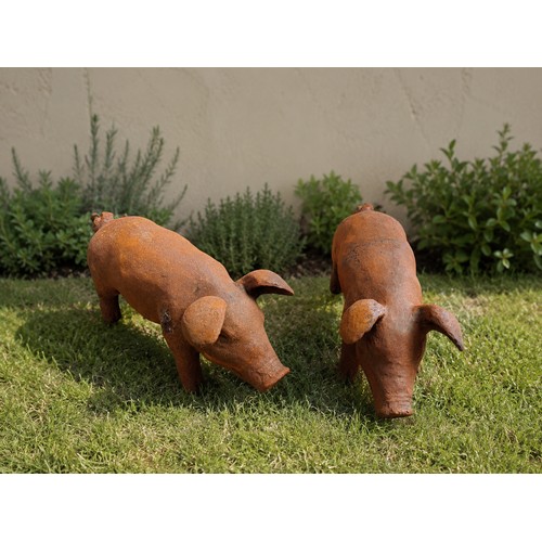 19 - Pair of cast iron piglets. {H 19cm x W 13cm x D 40cm}. NOT ON SITE FOR VIEWING