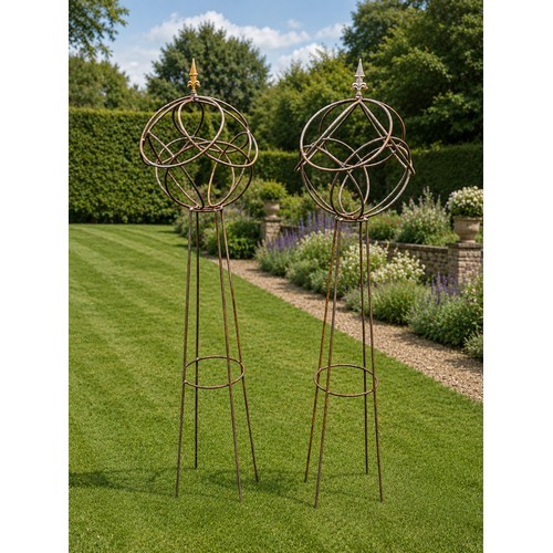 6 - Pair of wrought iron obelisks with sphere top and pointed finials. {158 cm H x 40 cm Dia.}.