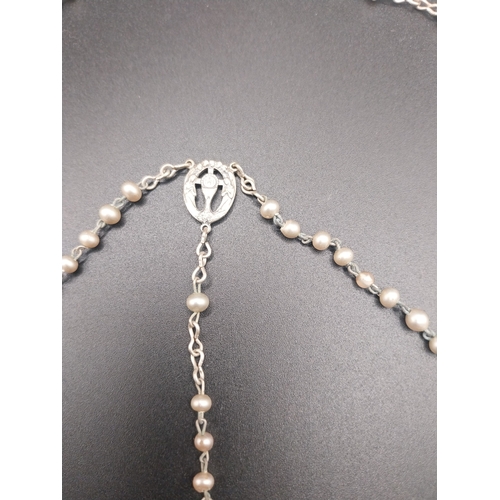 12 - Faux pearl rosary beads.