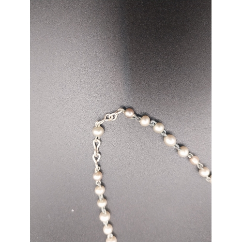 12 - Faux pearl rosary beads.