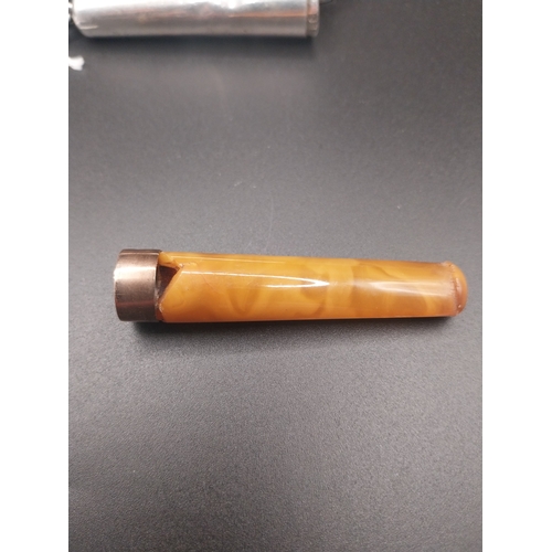 25 - Cigarette holder with amber insert in silver case. Hallmarked in London 1900. Wt: 20 grms.