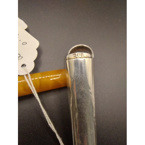 25 - Cigarette holder with amber insert in silver case. Hallmarked in London 1900. Wt: 20 grms.