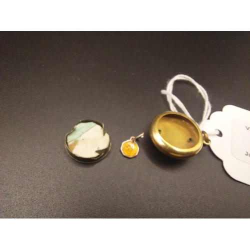 28 - Decorative locket with small medal inside.