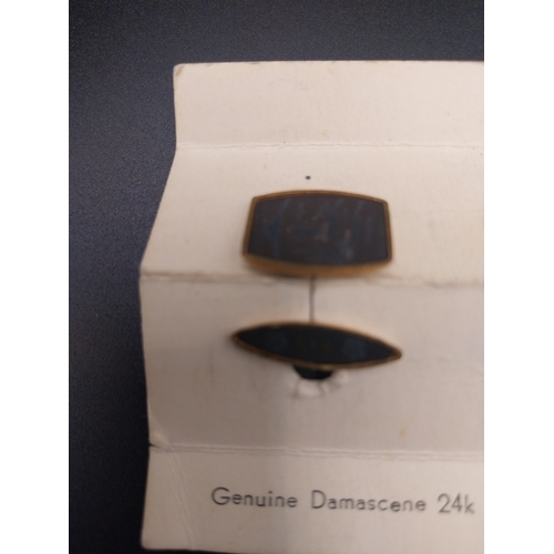 34 - Damascene 24 ct gold cuff links with Asian design.