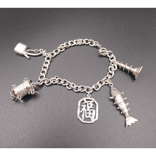 36 - Silver charm bracelet. Wt: 12.6 grms.