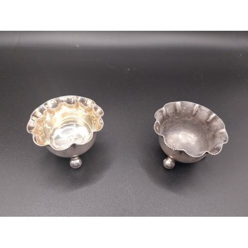 42 - Four silver salt pots with spoons. Hallmarked in London. Wt: 72.7 grms in total.