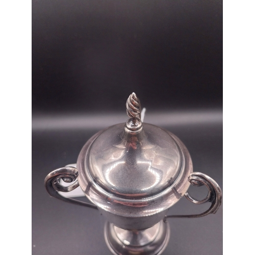 44 - Silver trophy. Hallmarked London. { 8 cm H x 6cm W}. Wt: 95.4 grms.