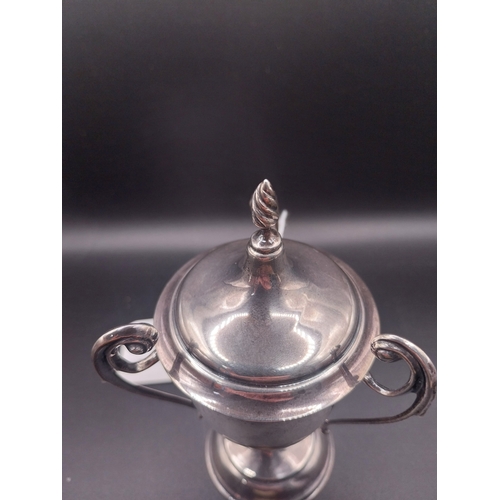44 - Silver trophy. Hallmarked London. { 8 cm H x 6cm W}. Wt: 95.4 grms.