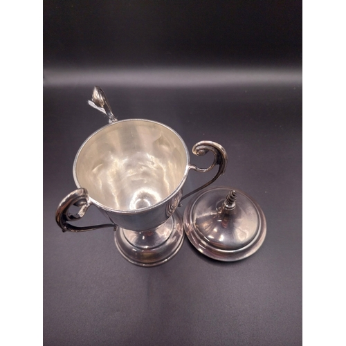 44 - Silver trophy. Hallmarked London. { 8 cm H x 6cm W}. Wt: 95.4 grms.