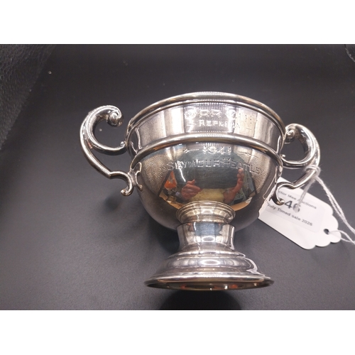 46 - Silver trophy. Hallmarked  London. { 6 cm H x 10cm W}.  Wt: 80 grms.