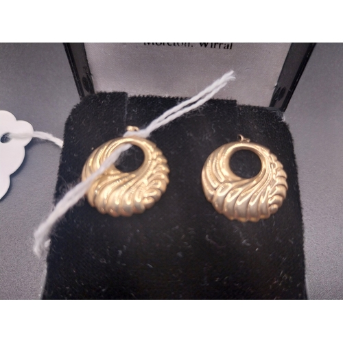 53 - Gold metal earrings.