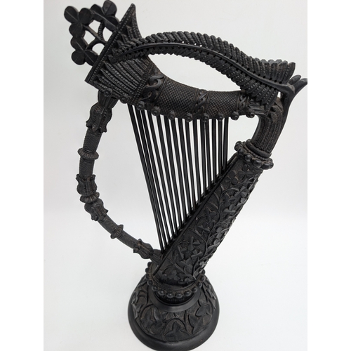 114 - 19th C. Irish bog oak Harp decorated with Shamrocks, oak leaves and ferns. {44 cm H x 22 cm Dia.}.