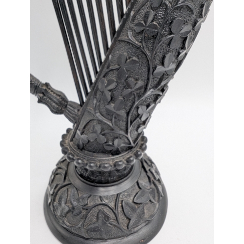 114 - 19th C. Irish bog oak Harp decorated with Shamrocks, oak leaves and ferns. {44 cm H x 22 cm Dia.}.