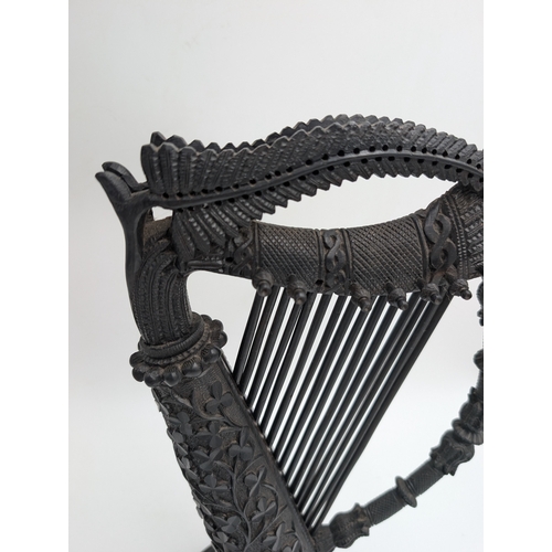 114 - 19th C. Irish bog oak Harp decorated with Shamrocks, oak leaves and ferns. {44 cm H x 22 cm Dia.}.