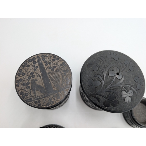 13 - Collection of nine 19th C. Irish bog oak boxes with various carvings of Wolfhound, Muckross Abbey et... 
