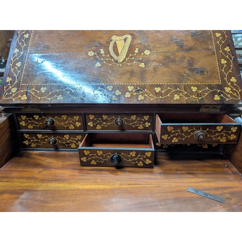 206 - 19th. C. Irish Killarney wood arbutus and marquetry davenport the raised panel back inlaid with a ce... 