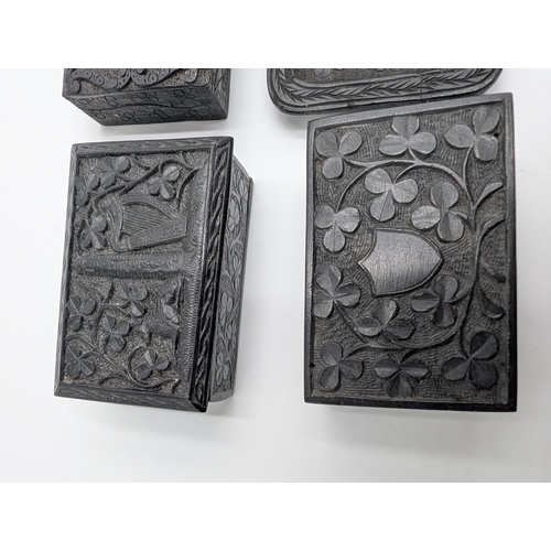21 - Collection of seven 19th C. Irish bog oak lidded boxes and a tray decorated with Shamrocks. {2 cm H ... 