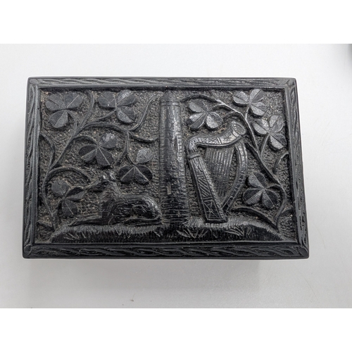21 - Collection of seven 19th C. Irish bog oak lidded boxes and a tray decorated with Shamrocks. {2 cm H ... 