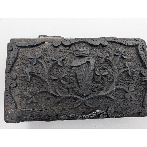 21 - Collection of seven 19th C. Irish bog oak lidded boxes and a tray decorated with Shamrocks. {2 cm H ... 