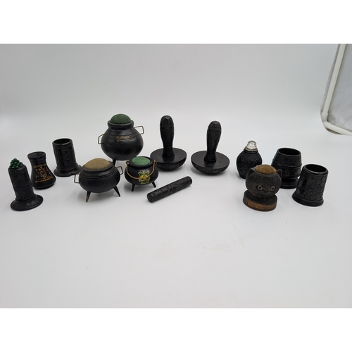 22 - Lot of 19th C. Irish bog oak sewing related items including pin cushions, pin holders etc.