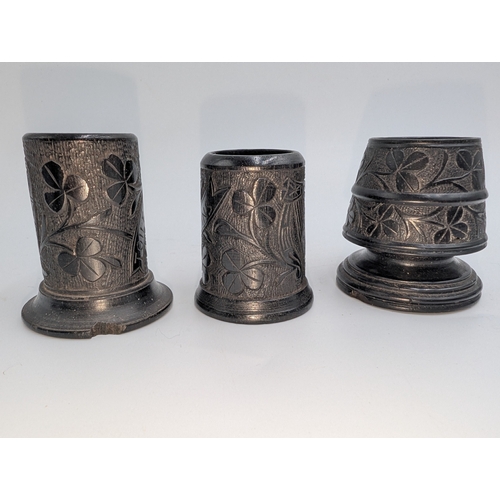 22 - Lot of 19th C. Irish bog oak sewing related items including pin cushions, pin holders etc.