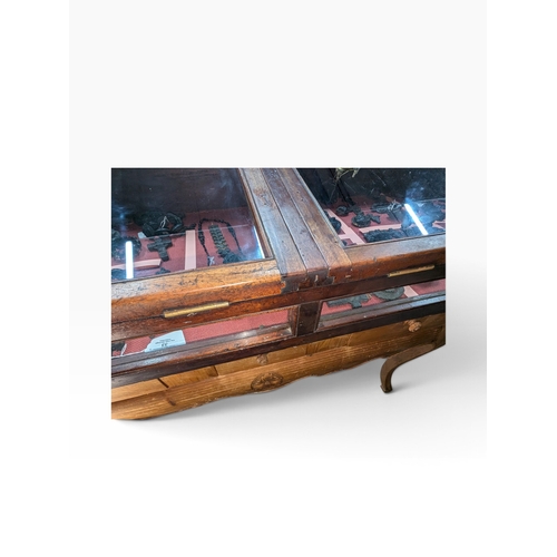 28 - Early 20th C. mahogany glazed counter display cabinet with key. {25 cm H x 145 cm W x 67 cm D}.