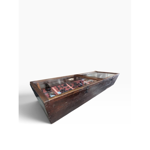 28 - Early 20th C. mahogany glazed counter display cabinet with key. {25 cm H x 145 cm W x 67 cm D}.