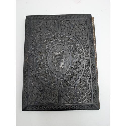 19th C. Irish carved bog oak Ledger decorated with Shamrocks and central Harp design. {31 cm H x 23 cm W}.